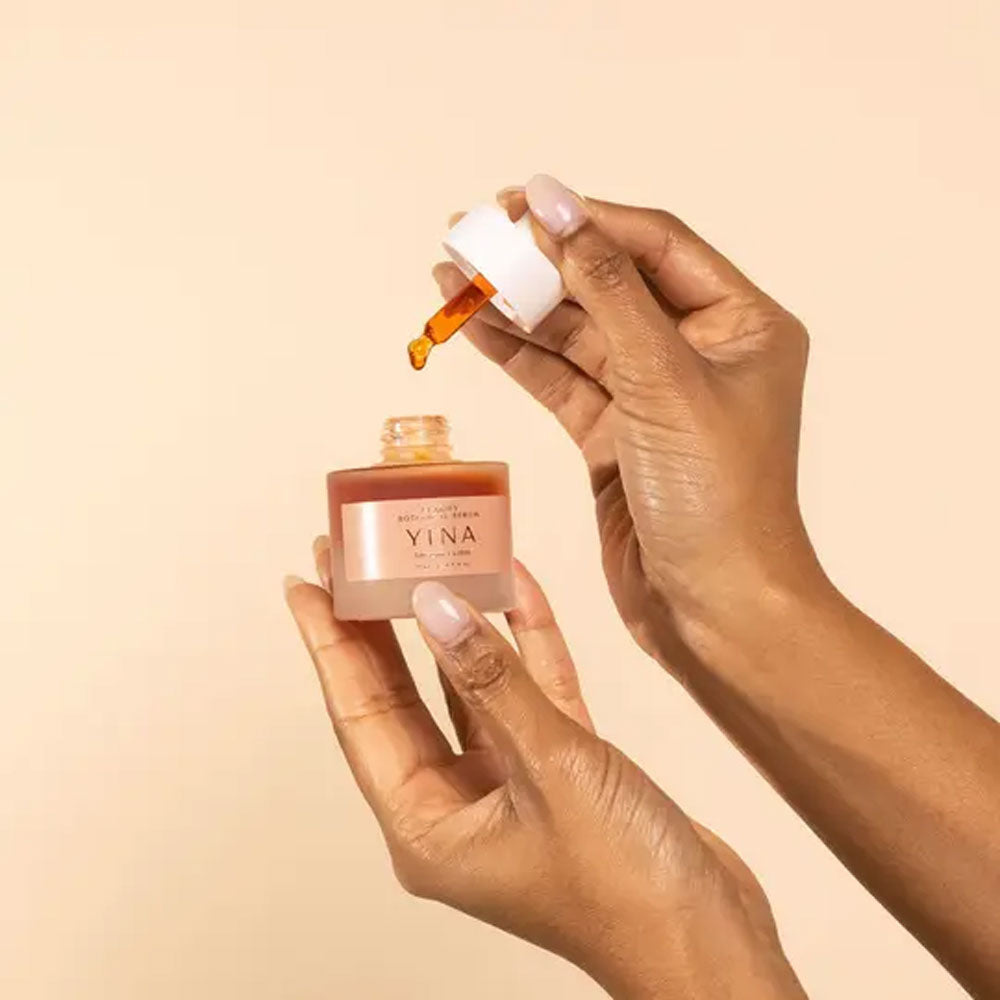 YINA clarify botanical serum dropper hand model