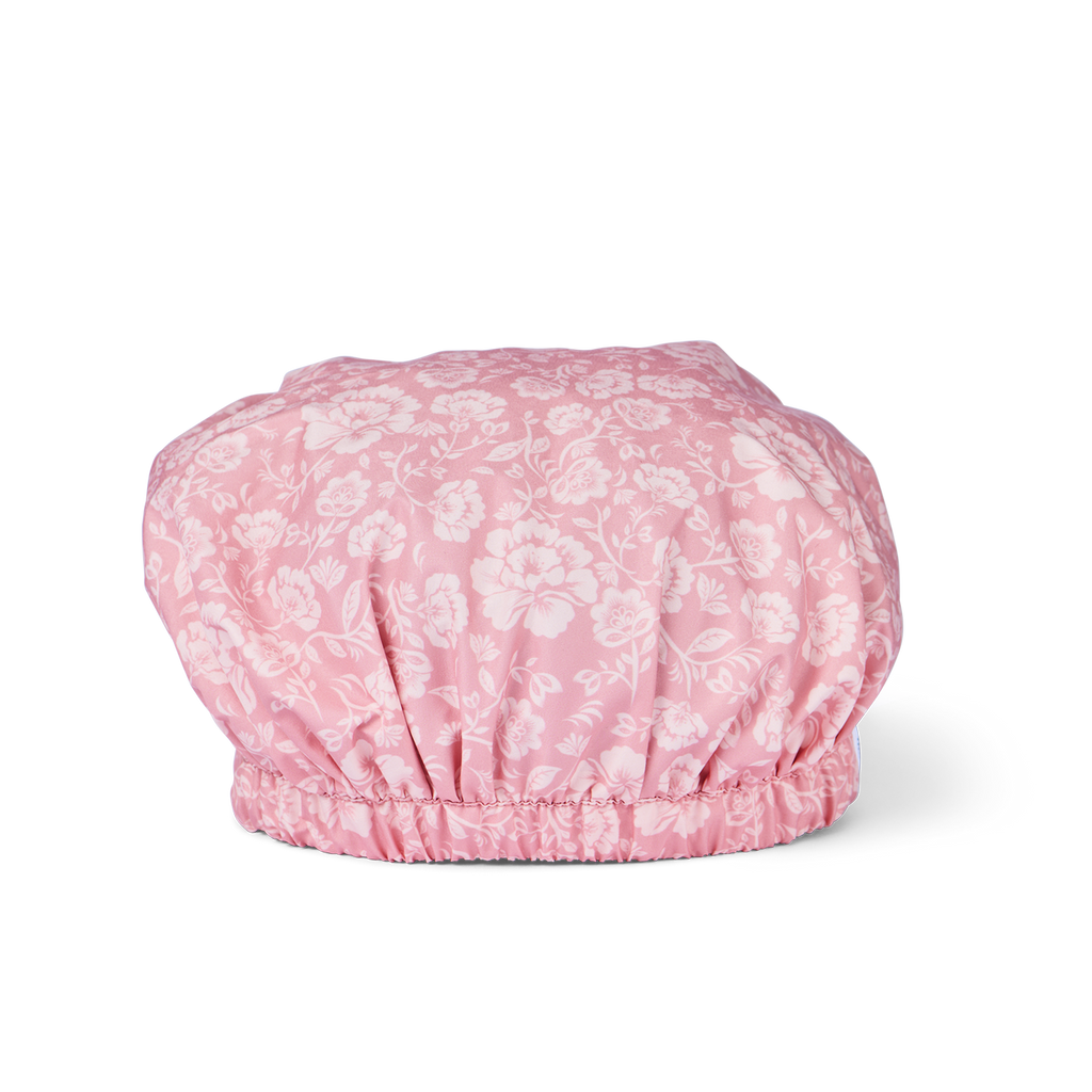 Pink floral-patterned shower cap on a white background