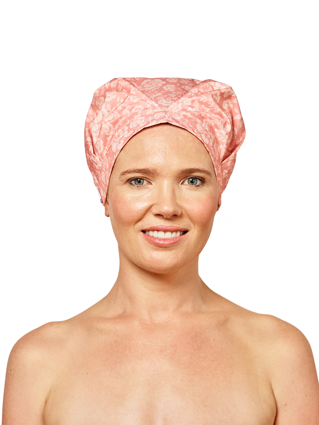 woman wearing musae mane shower cap in pink blossom print on a white background