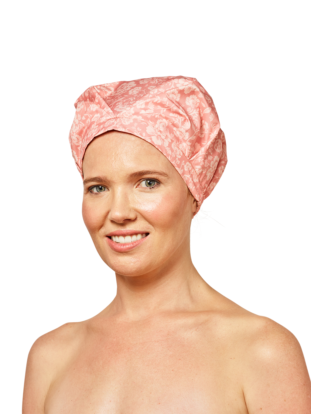 woman wearing musae mane shower cap in pink blossom print on a white background