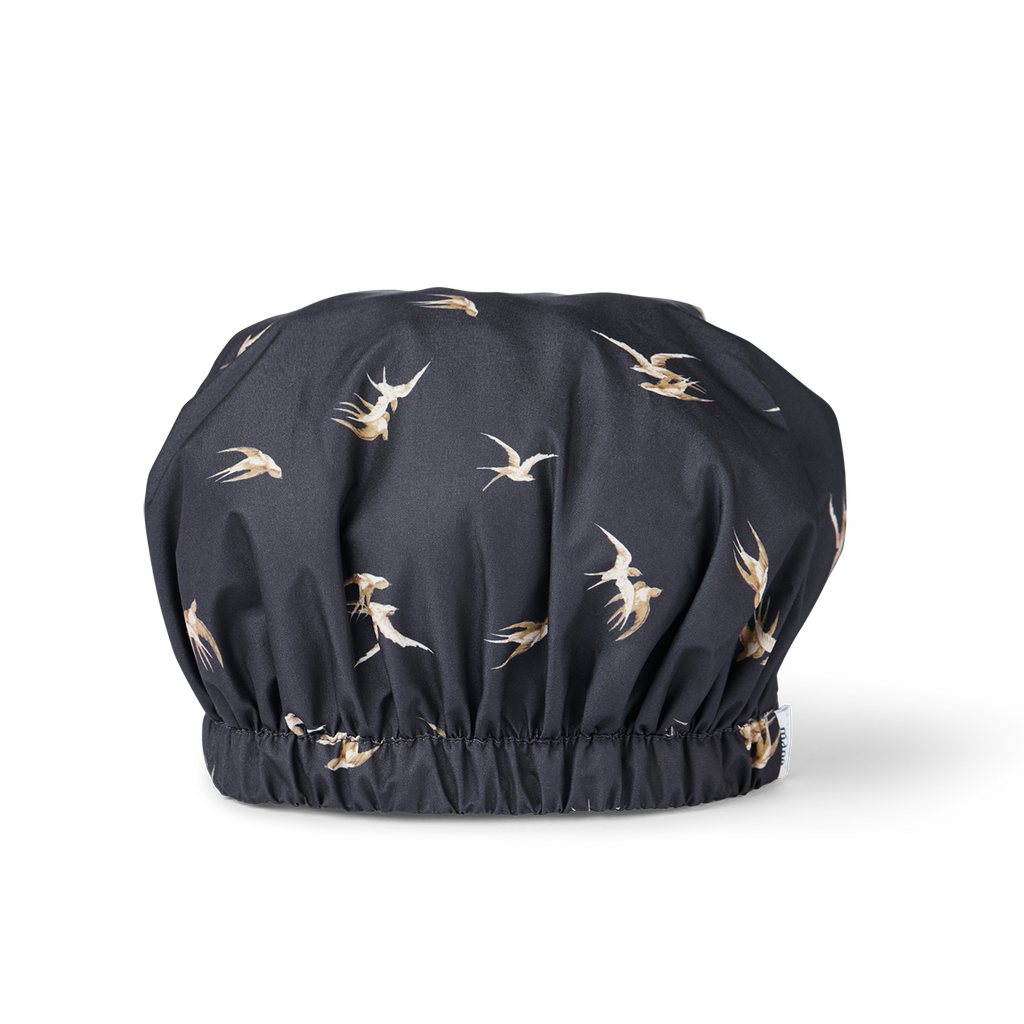 Black shower cap with bird pattern on a white background
